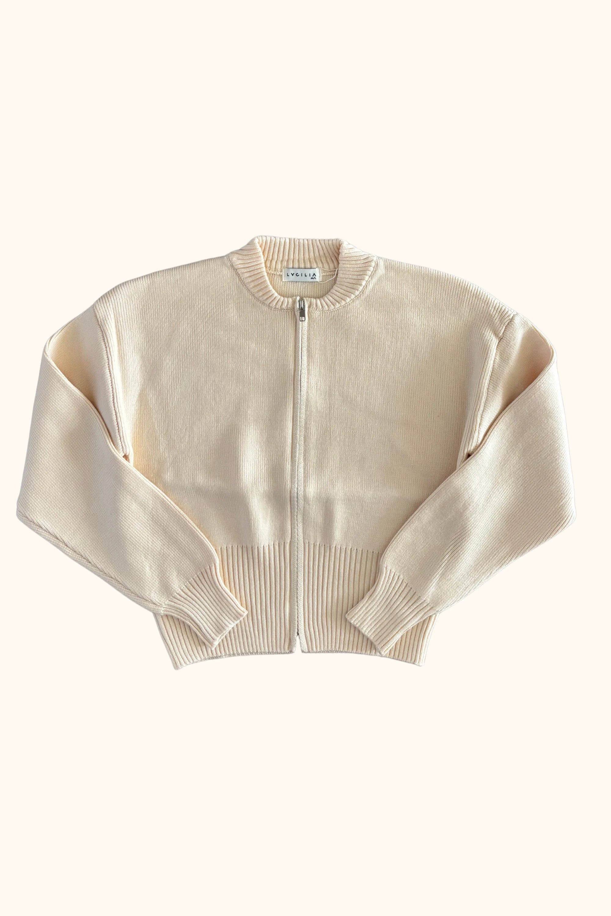 A cream-colored cropped knit zip-up sweater with ribbed collar, cuffs, and hem, displayed flat against a white background.