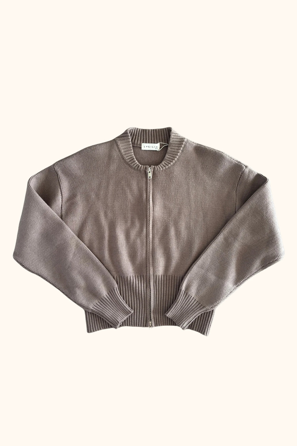 A cropped, long-sleeve knit zip-up cardigan in a muted taupe-brown color, featuring ribbed collar, cuffs, and hem, with a silver-tone zipper.