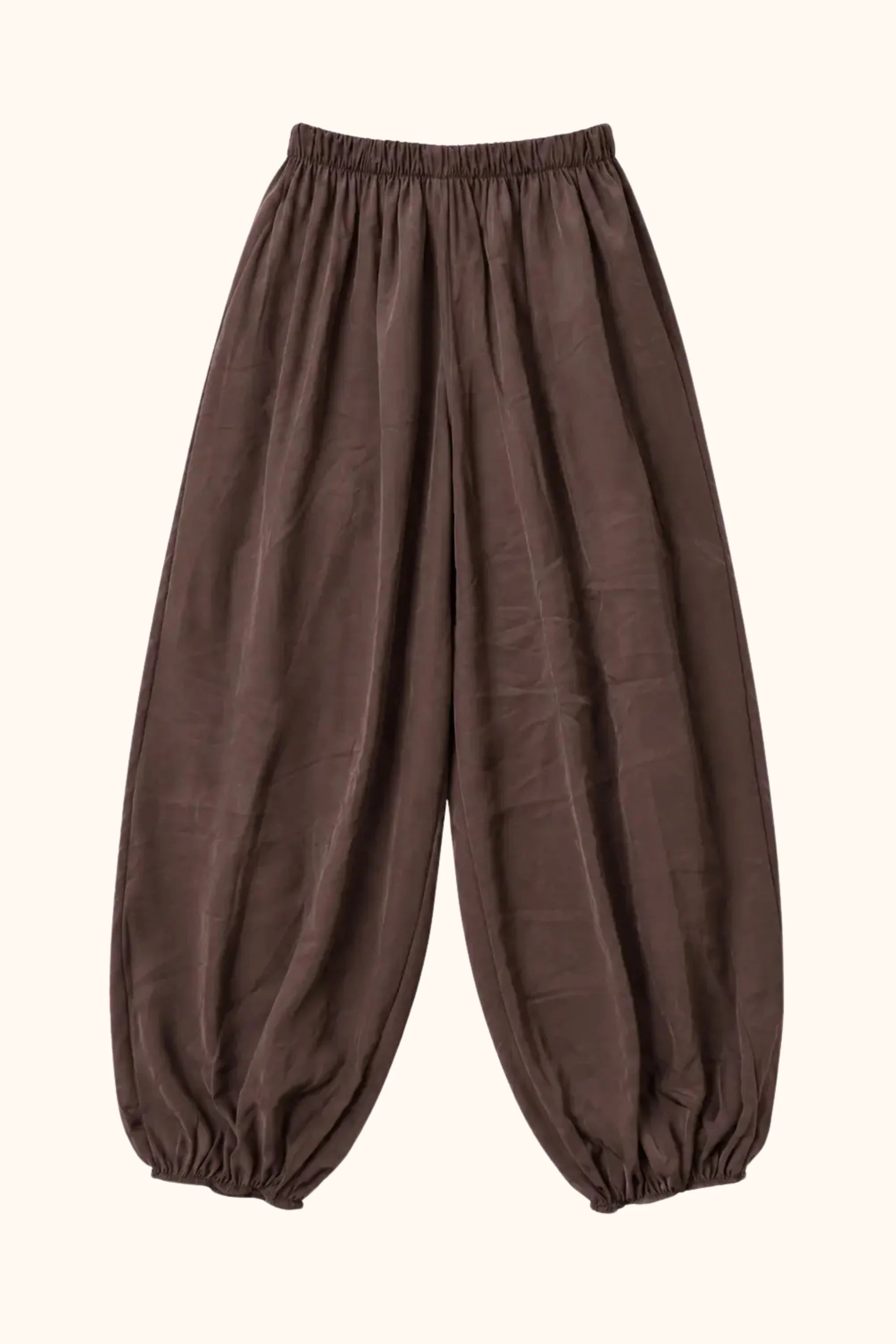 A pair of loose-fitting brown harem-style pants with an elastic waistband and gathered elastic cuffs at the ankles, shown against a plain white background.